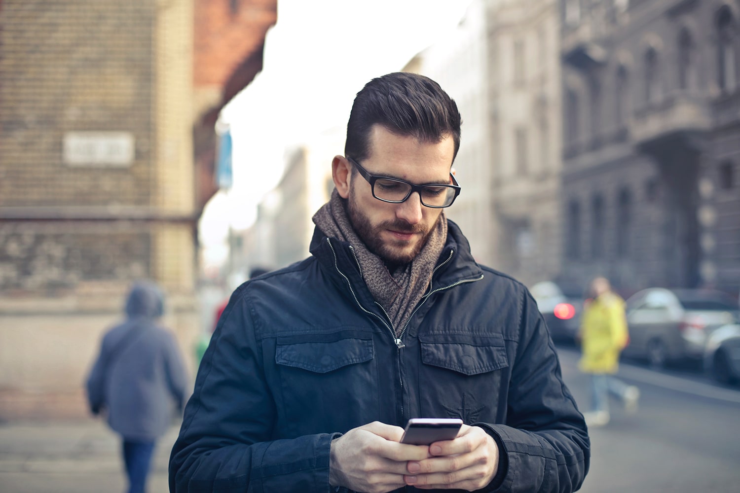 Man using myQ app on smartphone